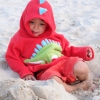 kid in the sand wearing a kentrosaurus hoodie