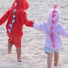children wearing spiked dinosaur hoodies