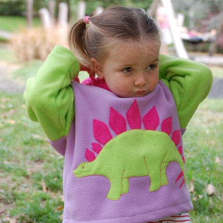 girl wearing stegosaurus hoodie