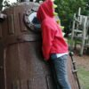 model wearing red t-rex hoodie side view