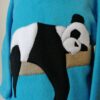 close up of panda applique on blue hoodie