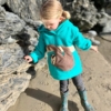 girl on the beach in sloth hoodie